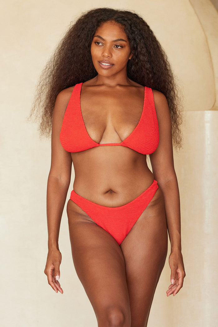 Front of Palm Springs Top in Chili Pepper Crinkle showing tall triangle cups and crinkle texture on beige background