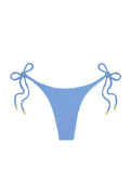 Blue textured bikini bottom with side-tie bows and gold-tipped cords on white background.