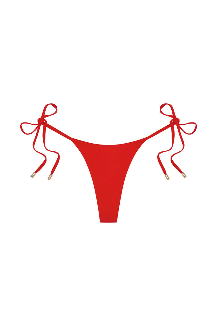 Flat lay Palma Thong in Chili Pepper showing thong cut, adjustable side ties with gold tips on white background