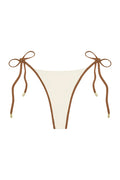 Front view of Palma Thong showing ivory color block panel with caramel brown trim and tie-side straps with gold tips on white background
