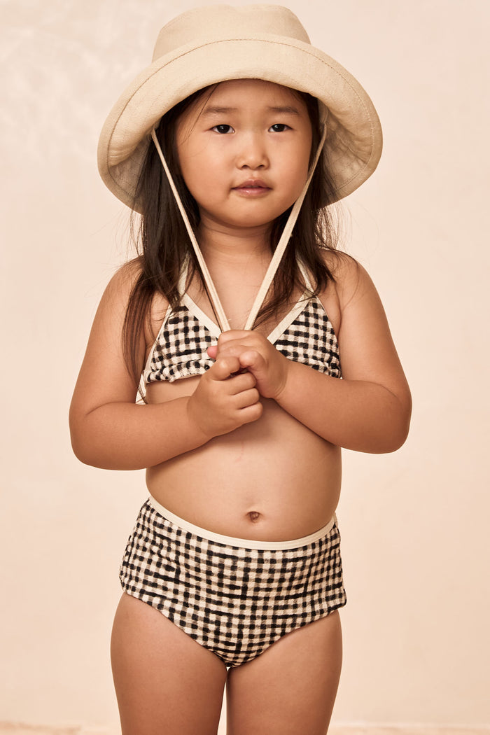 Front view of Palma top and Seychelles bottom in black gingham on child model, showing triangle top and high-waist bottoms