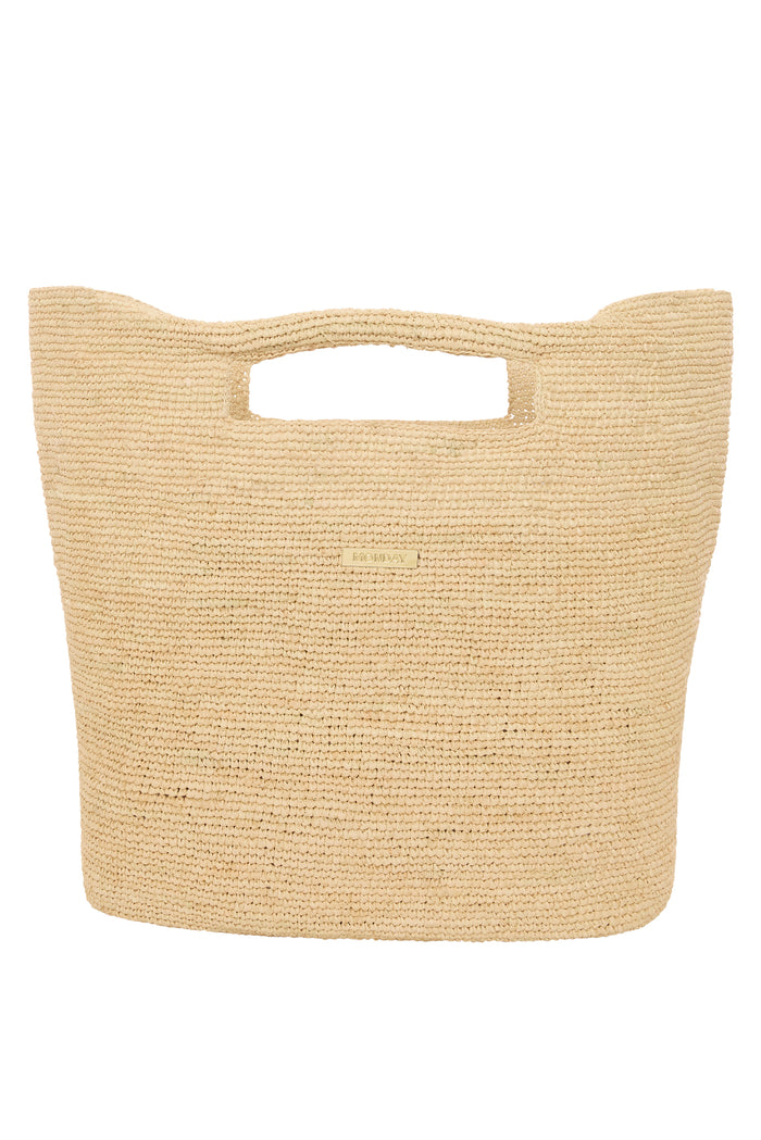 Close-up front of Paloma Bag (Large) showing hand-crocheted straw texture, cutout handles and gold MONDAY logo on white