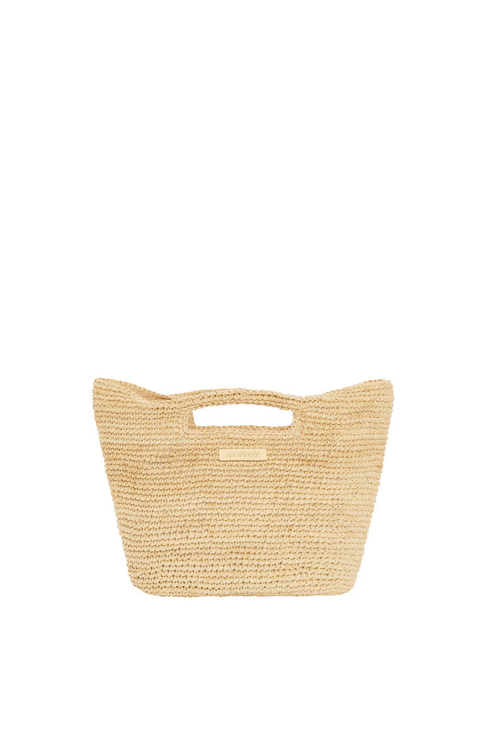 Front view of Paloma Mini Bag showing natural straw crochet texture, built-in top handle and gold MONDAY logo on white background