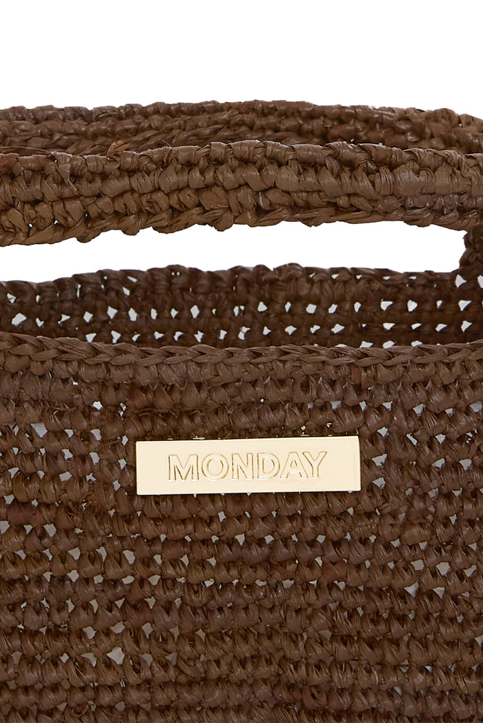 Close-up of Paloma Mini Bag Espresso showcasing braided raffia weave and gold MONDAY logo on white background