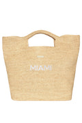 Cropped front view of Paloma Miami straw bag showcasing MIAMI white embroidery, built in handles and gold logo on white