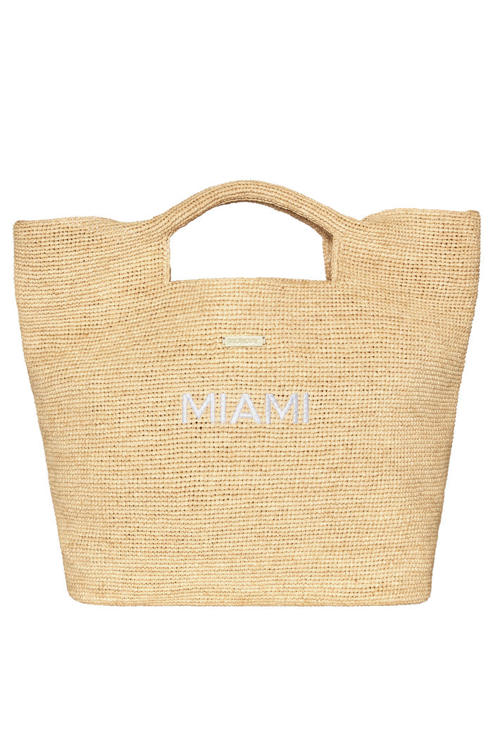 Cropped front view of Paloma Miami straw bag showcasing MIAMI white embroidery, built in handles and gold logo on white
