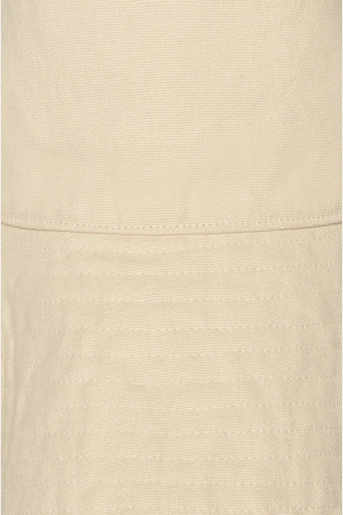 Close-up of Panarea Hat in Natural showing woven straw texture, horizontal seam and parallel stitched rows