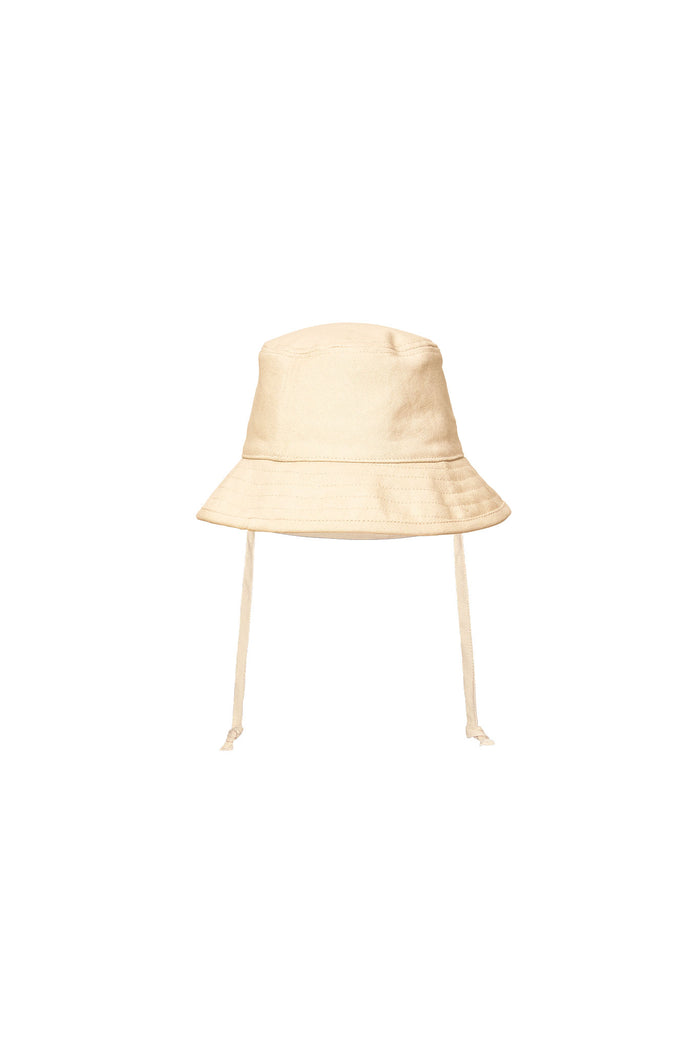 Front view of Panarea Mini Hat in natural canvas showcasing short bucket brim and chin tie on white background