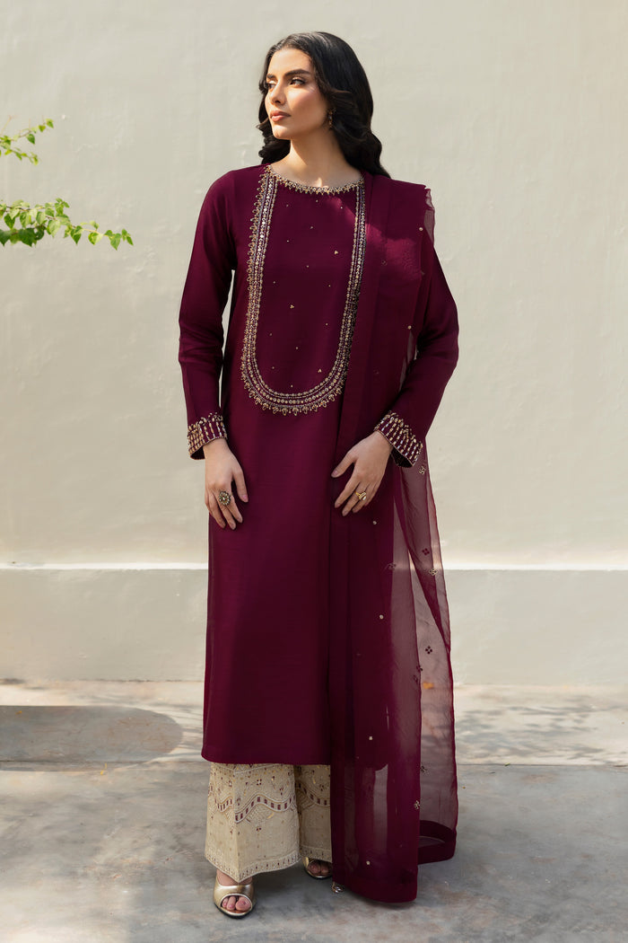 Stylized ensemble
Model wearing full NAQSHI Parize set: burgundy hand‑adda shirt, skin culottes with sequin detailing and crystal‑tassel organza dupatta for a refined festive look.