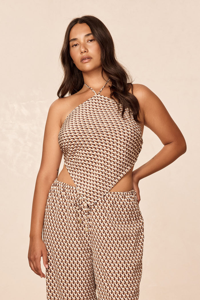 Front view of Prato Top in Husk Geo Silk, brown-and-cream geometric print, halter neck, handkerchief crop, beige background