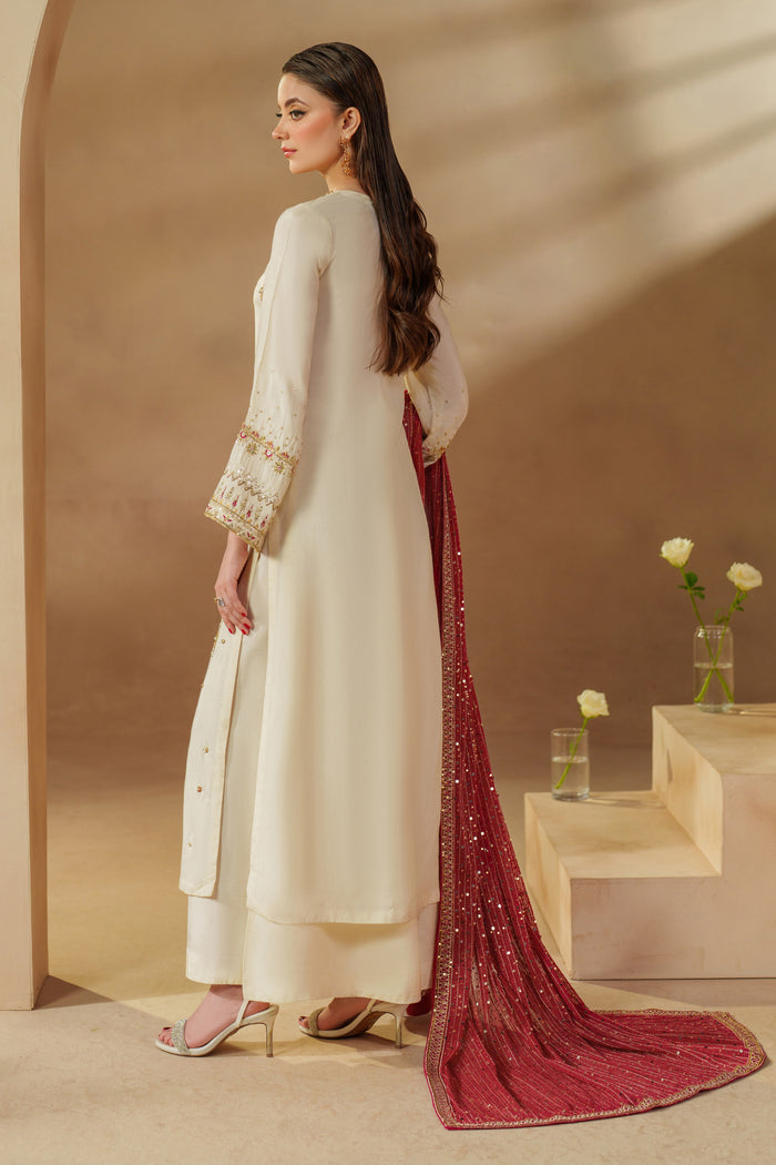 Side pose of NAQSHI Rabeel premium off-white dress set highlighting rich texture, craftsmanship, and refined ready-to-wear design