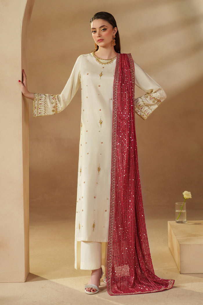 Model wearing NAQSHI Rabeel off-white formal dress with artisan sequins and adda work, styled for party wear and formal gatherings