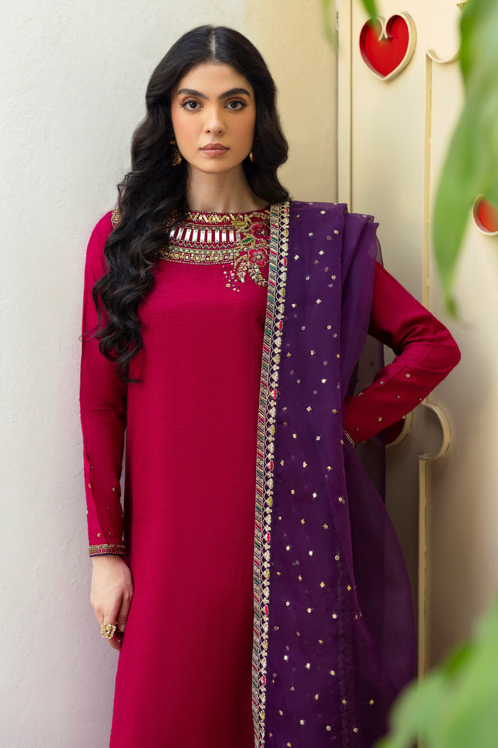Close-up of NAQSHI Raima neckline showcasing dense hand-adda embroidery in kora, dabka, naqshi, sitara, cut-dana, crystals, sheet & stone on hot-pink fabric.