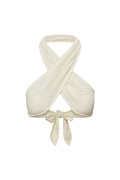 Front close up of Ramatuelle Top in ivory lace crochet showing crisscross halter wrap and tied bow on white background