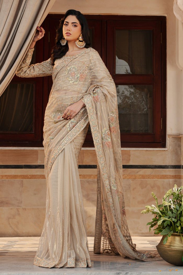 Side profile of NAQSHI Ramish saree highlighting flowy net pallu with embroidered floral motifs and fitted blouse silhouette in skin tone