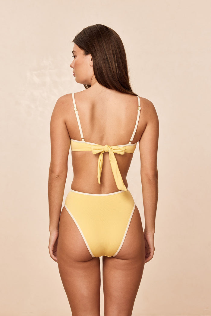 Rear view of Ravello Bottom in Meyer Ivory showing high waisted fit, high leg and cheeky coverage on neutral beige background