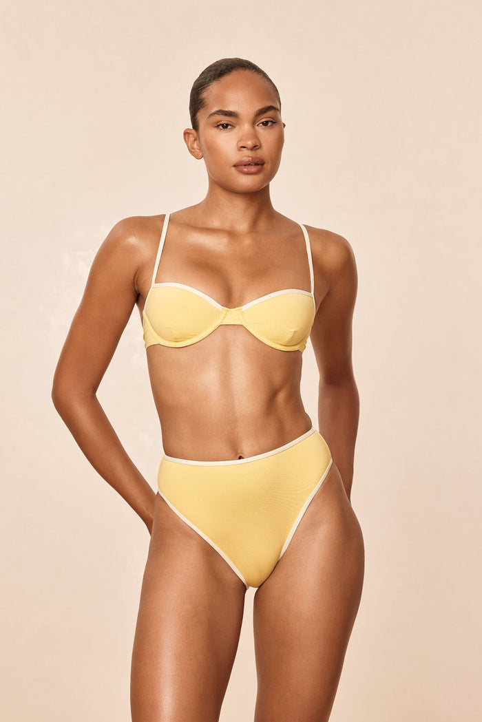 Front view of Ravello Bottom Meyer Ivory showcasing high‑waisted fit, high leg and cheeky coverage on beige background