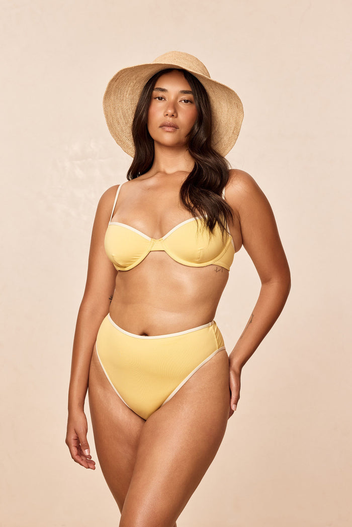 Front view of Ravello Bottom in Meyer/Ivory on model showing high-waisted fit and high-leg cheeky coverage, beige background
