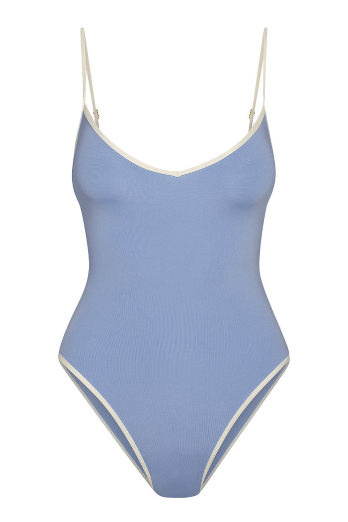 Periwinkle-blue one-piece swimsuit with cream trim and adjustable spaghetti straps.