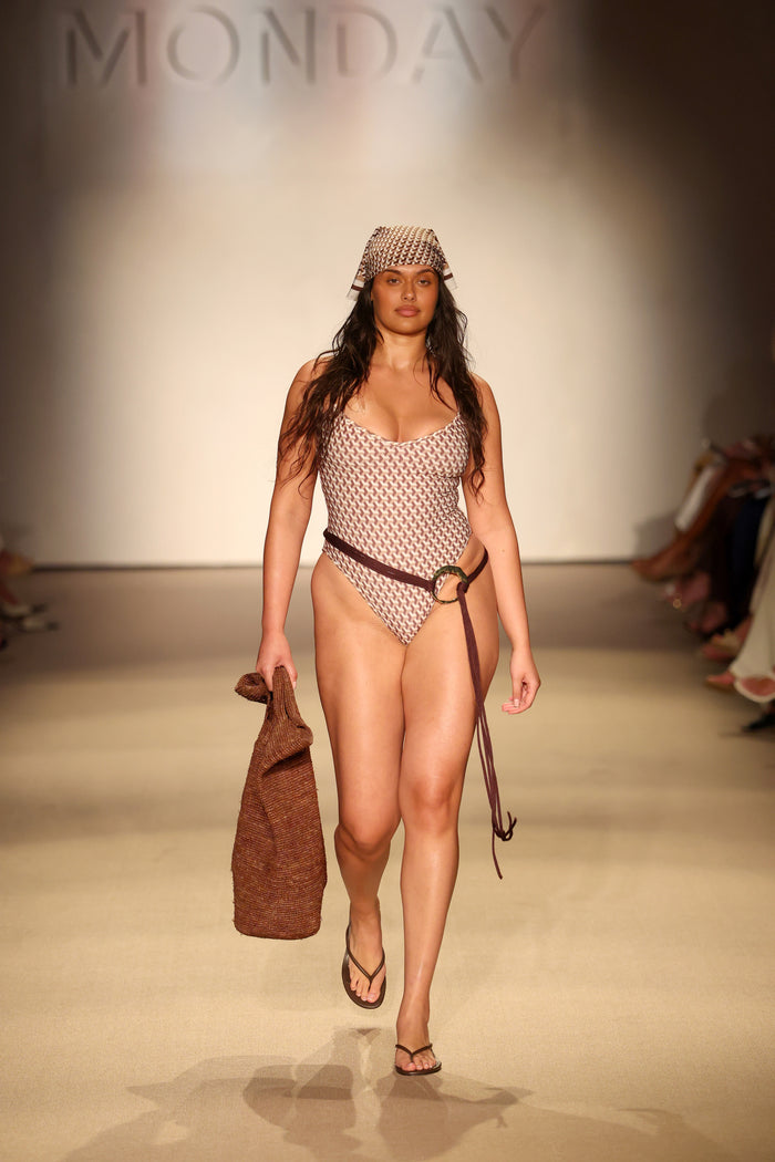 Front view of Ravello One Piece in Husk Geo showing wide V neckline, adjustable straps, and cheeky coverage on runway