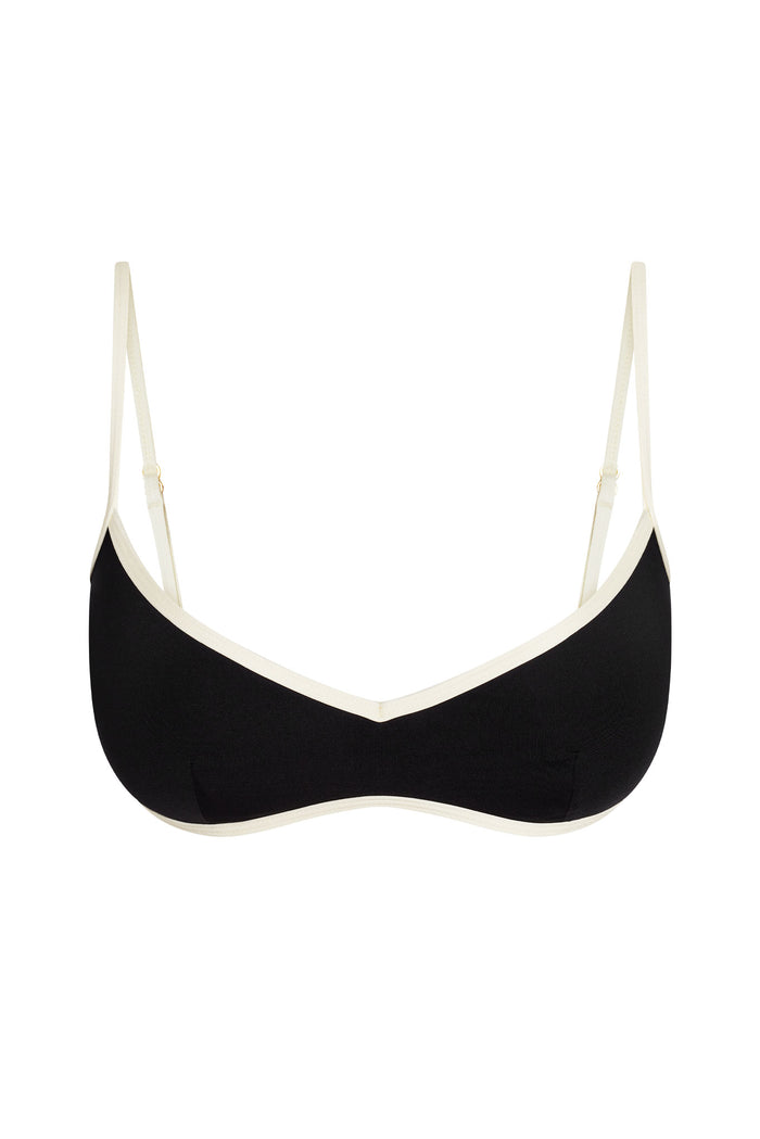Front view of Ravello Top in black and ivory with V-neckline, contrast ivory trim and adjustable straps on white background
