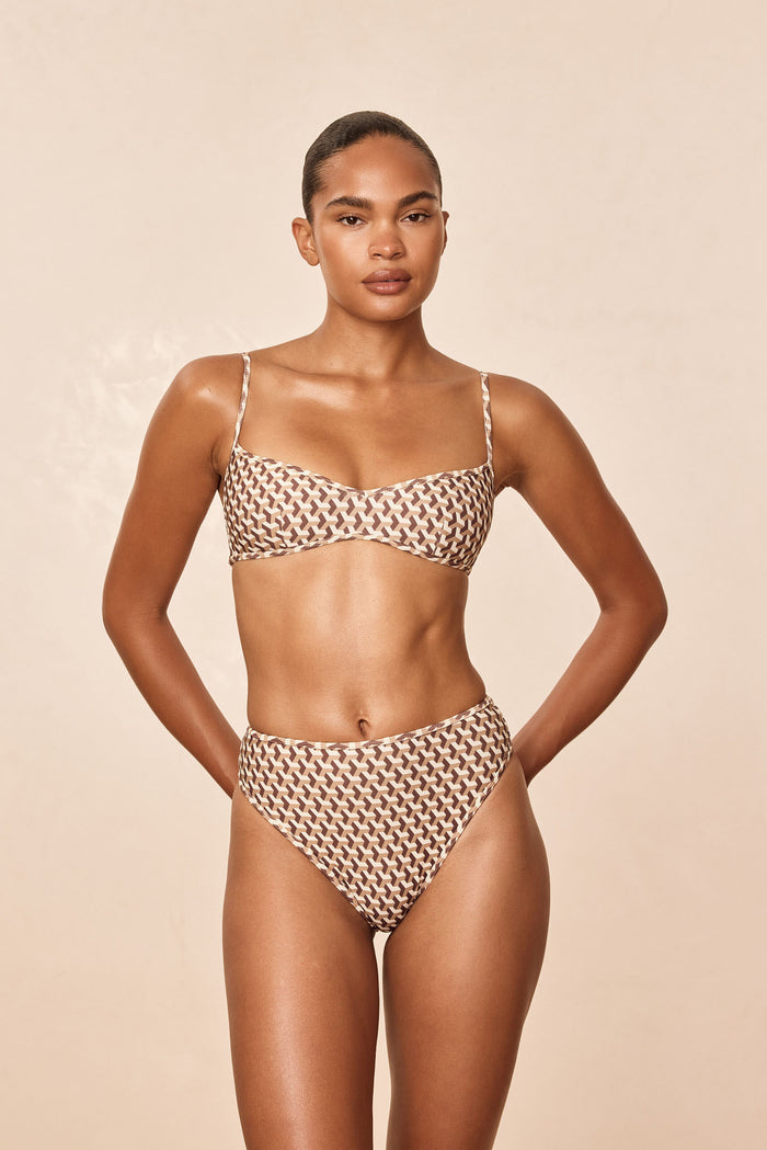 Front view of Ravello Top in Husk Geo showcasing square neckline and adjustable straps on model against a neutral beige background