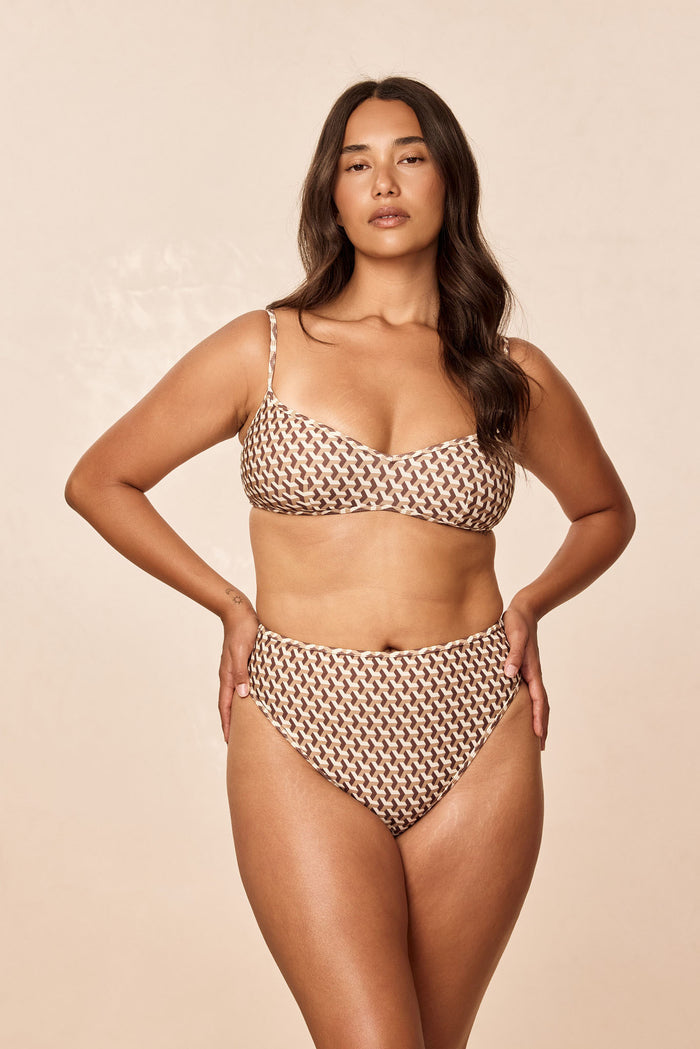 Front view of Ravello Top in Husk Geo showcasing scoop neckline and thin adjustable straps on a model against a neutral beige background
