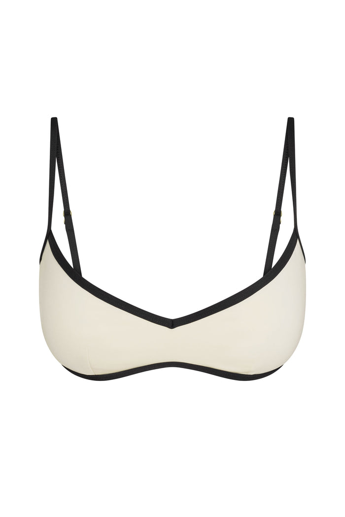 Front view of Ravello top in ivory with black contrast trim and adjustable straps on white background