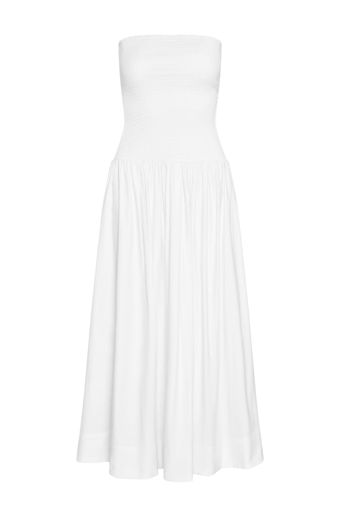 Front view of Rio Dress in white showcasing strapless smocked bodice and gathered maxi skirt on plain background