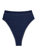 Front flat lay of Riviera high-waist bikini bottom in blue denim showing high-cut leg and contrast stitching on white