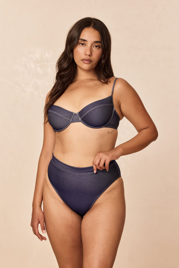 Front view of Maui Top in blue denim showcasing underwire cups and thin adjustable straps on a model with a neutral beige background
