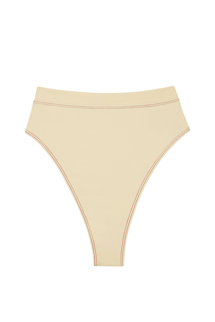 Front flat-lay of Riviera Bottom high-waist bikini bottom in champagne denim with high-cut leg and contrast stitching on white background