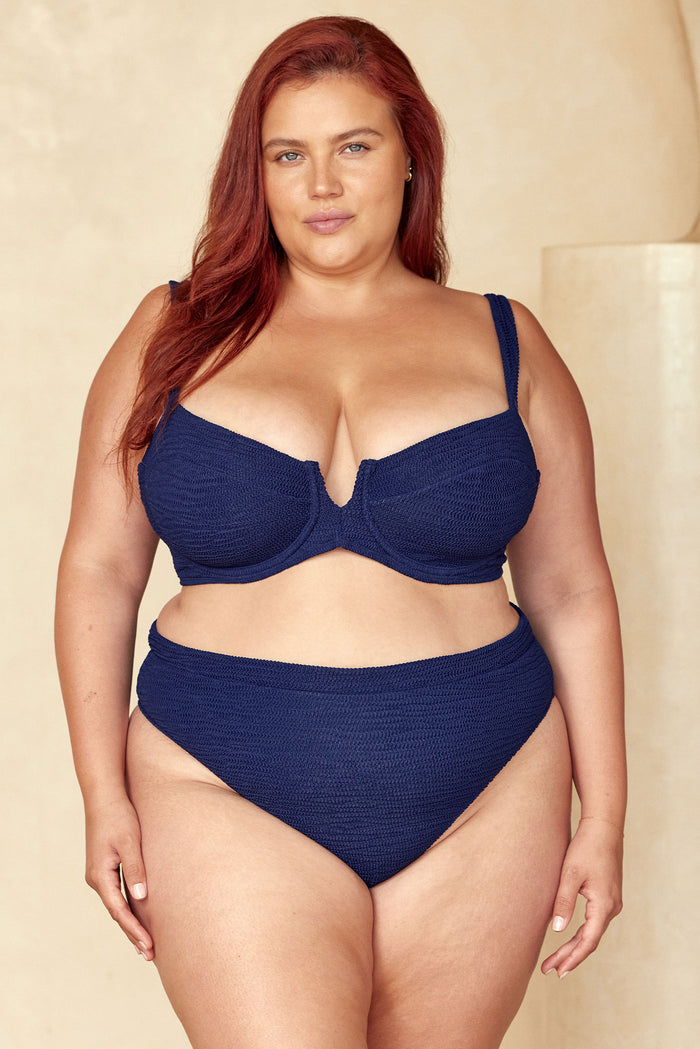 Front view of Riviera Bottom in Midnight Crinkle showcasing high‑waist crinkle texture on model against a neutral beige background
