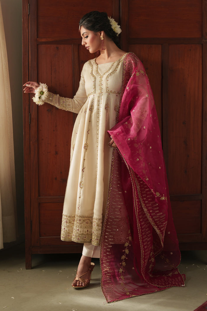 NAQSHI Rumi front view: off‑white viscose Masoori frock with adda embroidery at neckline, subtle front slit, fitted sleeves, paired with raw‑silk trousers