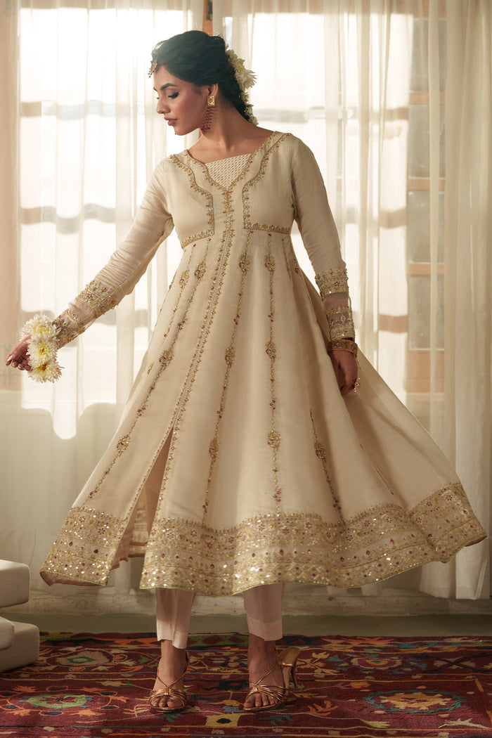 Model wearing full NAQSHI Rumi 3PC: intricately embroidered viscose frock with front slit, raw‑silk trousers & sequined organza dupatta for formal event styling