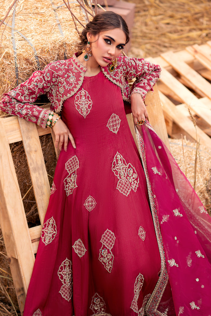 Model wearing full Naqshi Samar 3PC set: carrot orange paneled frock, open embroidered jacket and ornate organza dupatta styled elegantly for festive occasions.