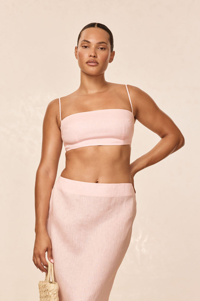 Front view of San Diego Top in Powder Pink Linen on model showcasing straight bandeau neckline, thin straps, cropped fit