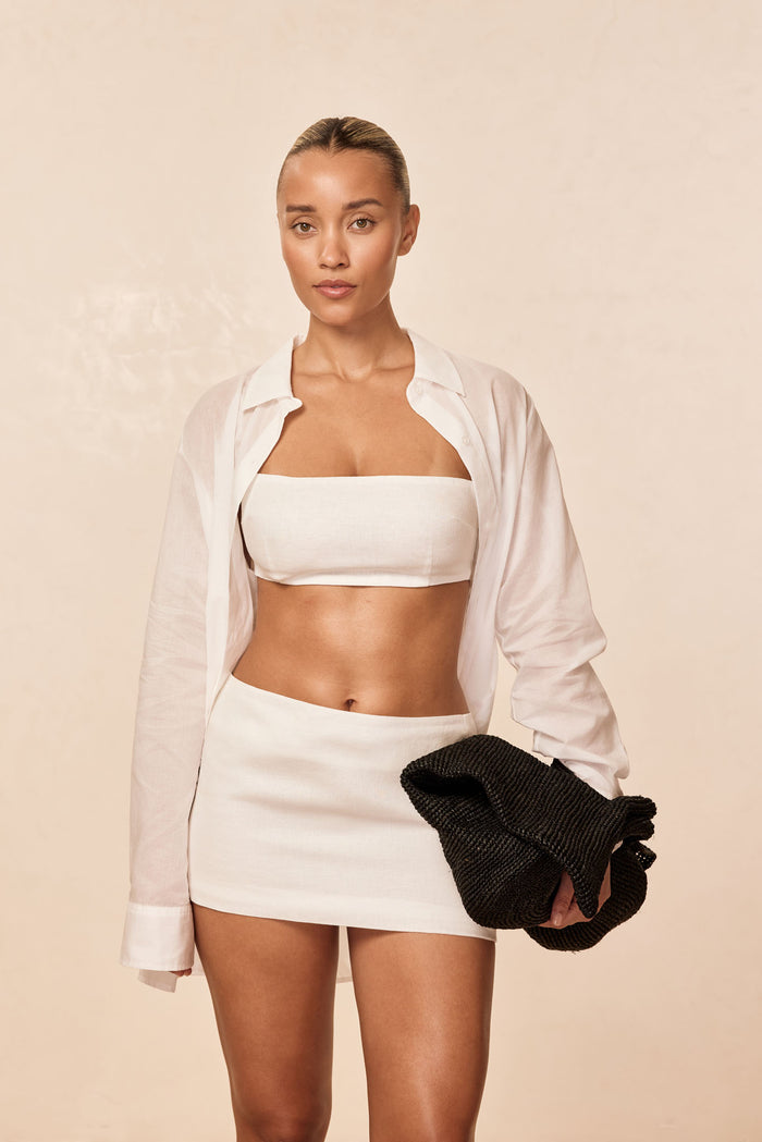 Front view of San Diego Top in White Linen showcasing strapless bandeau fit on model with matching mini skirt and beige background