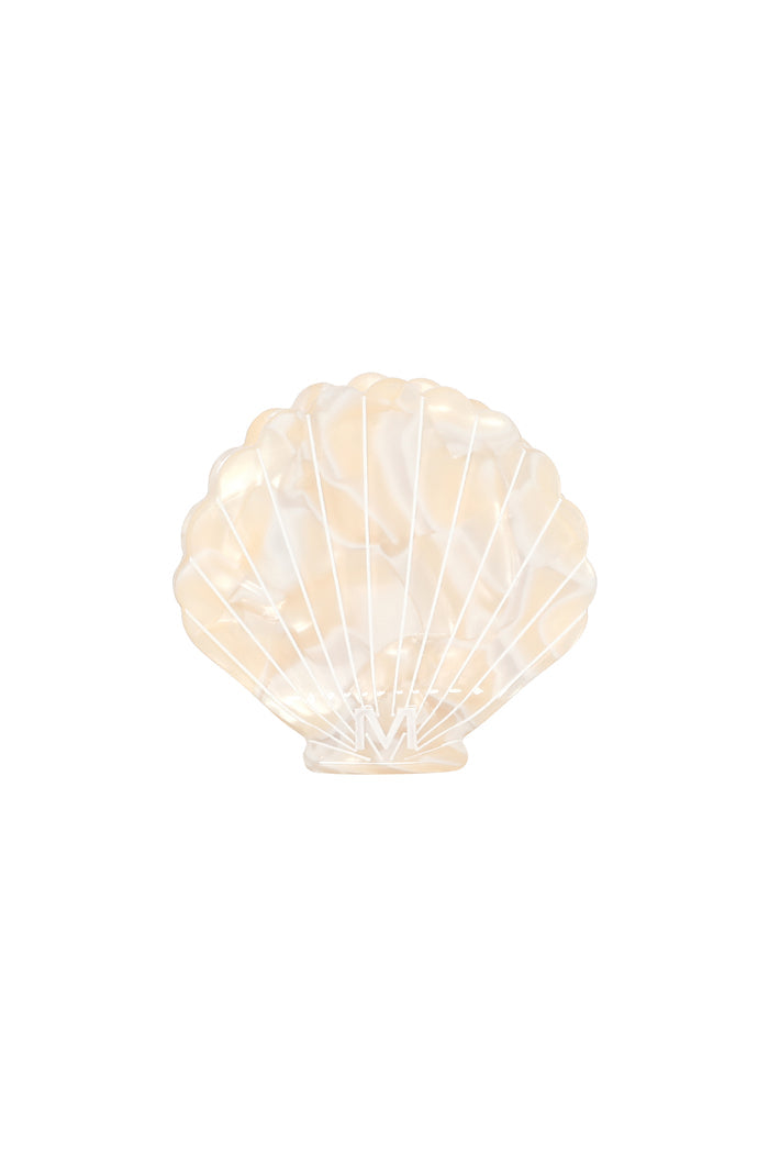 Front view of Sanibel Shell Hair Clip, ivory swirl, showing pearlescent scallop-shell shape, molded ridges, and white M logo on white background