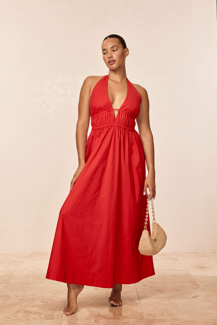 Three-quarter view of Santa Cruz Dress in Chili Pepper on model, plunging halter V, elastic underbust, ankle-length