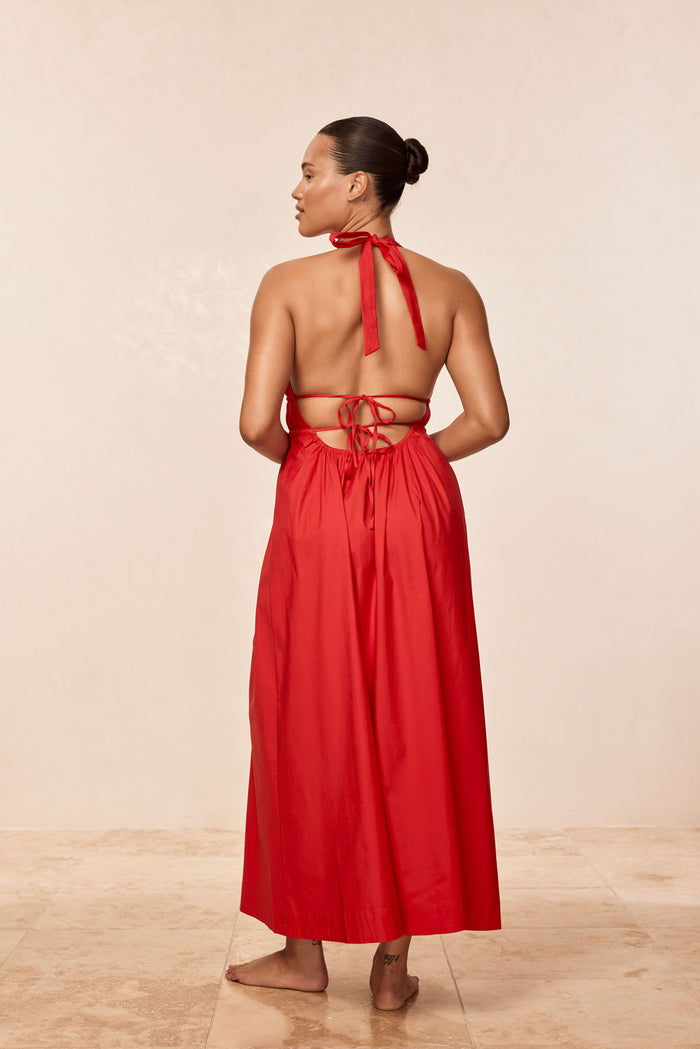Rear view of Santa Cruz Dress in Chili Pepper showing halter neck tie, adjustable back ties and ankle-length skirt on neutral background