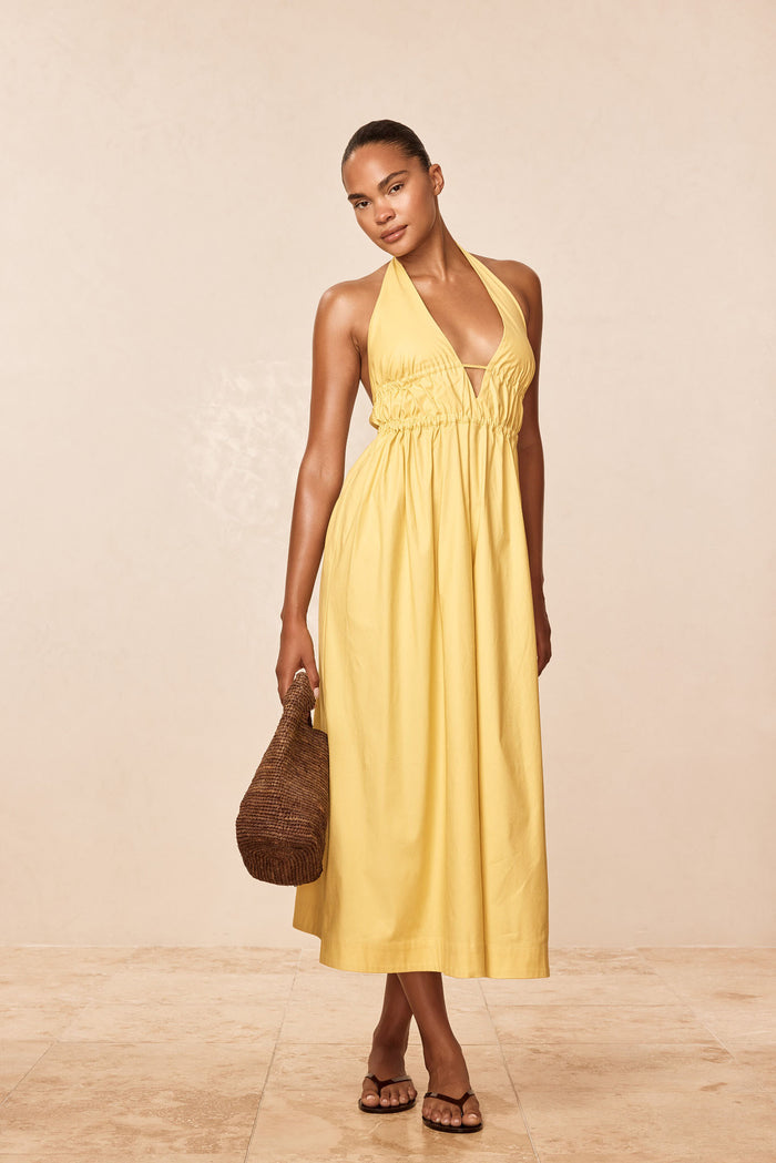 Front view of Santa Cruz Dress - Meyer in yellow on model, showing halter V neckline, elastic waist, ankle-length silhouette