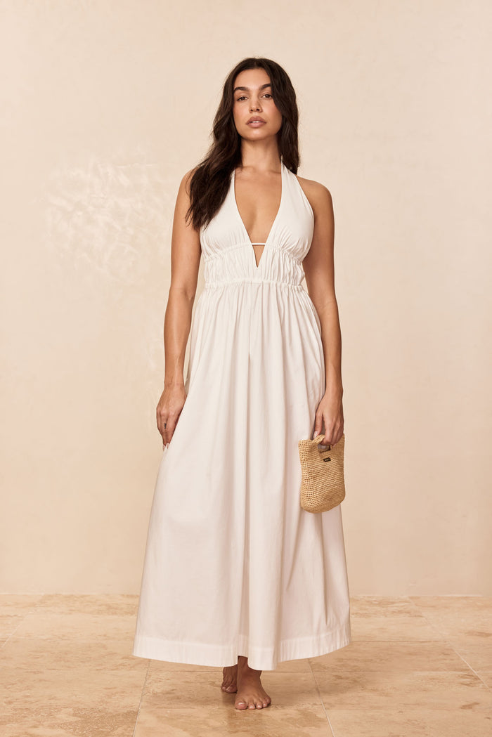 Front view of Santa Cruz dress in white showing plunging halter V neckline, elastic underbust, ankle-length
