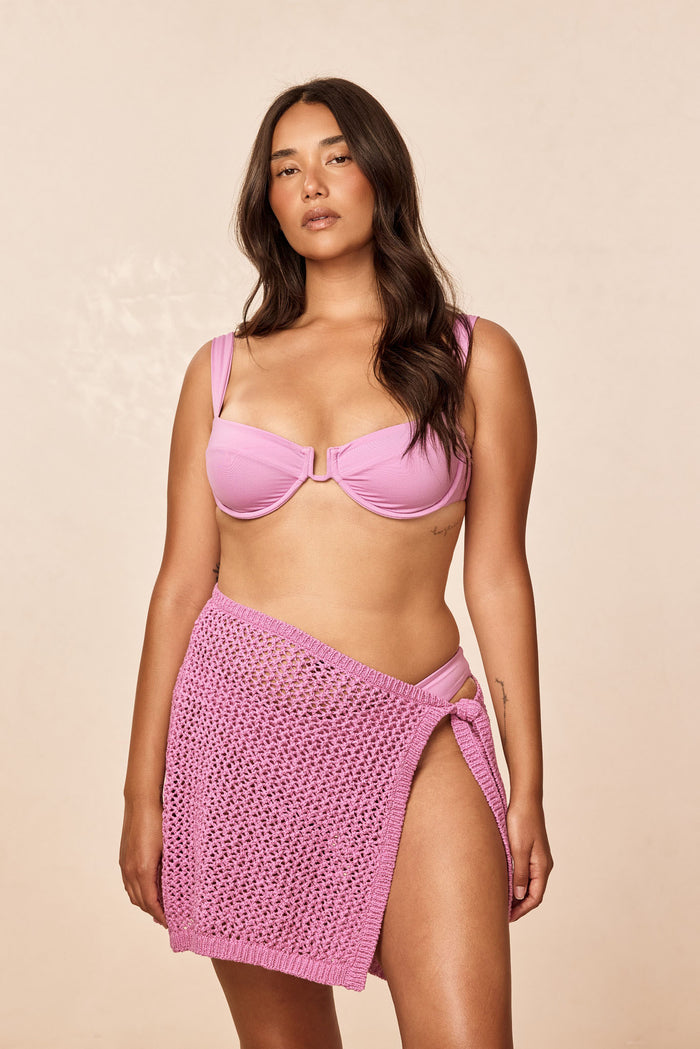 Front of Santa Marta Sarong in Moonlight petit crochet, adjustable wrap side tie and open knit, beige backdrop