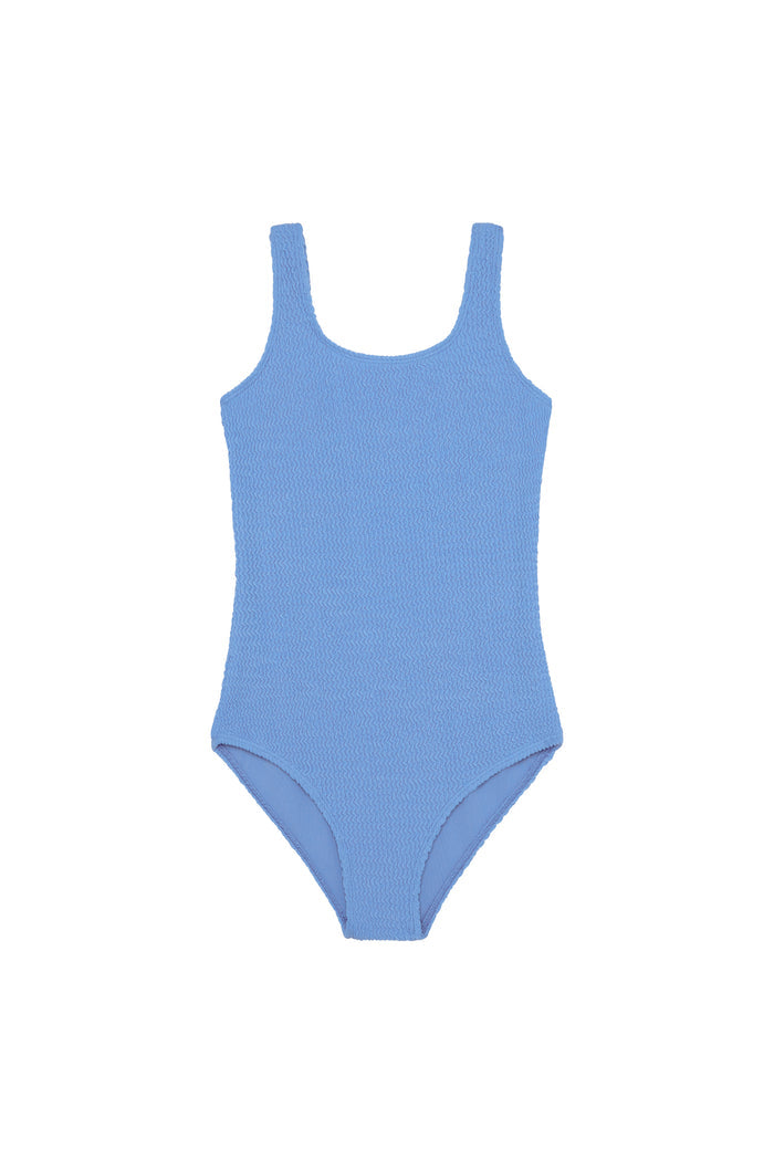 Flat-lay of Sardinia one-piece Azure Crinkle with crinkled texture, scoop neckline and wide straps on white background