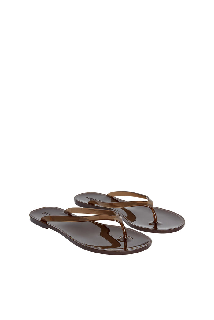 Three-quarter view of Sardinia Sandal in Espresso showing glossy jelly straps and debossed heel logo on white background