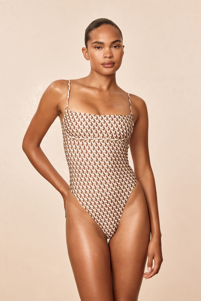 Front of Sausalito One Piece Long in Husk Geo showing scoop neckline, under-bust support, adjustable straps and high-cut leg