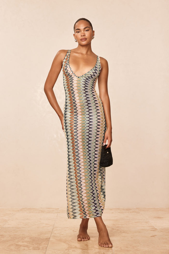 Three-quarter view of Sayulita Dress in Porto Cervo Multi, fitted crochet knit with deep V-neck and adjustable straps on model