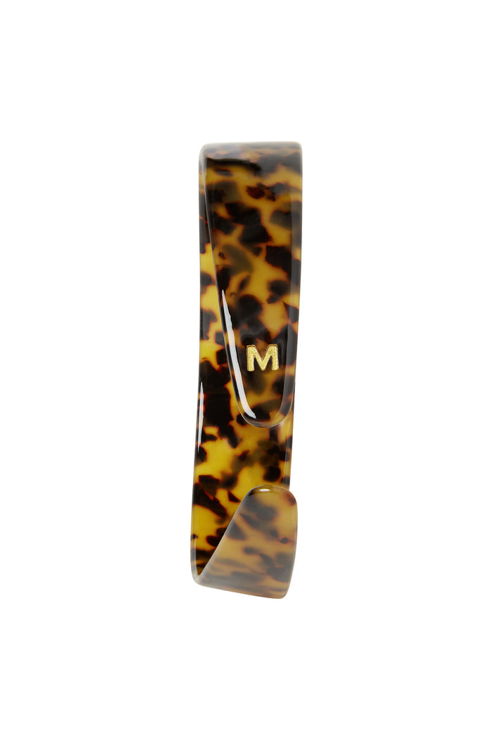 Front view of Sayulita Headband in tortoise acetate showcasing small gold M logo on white background