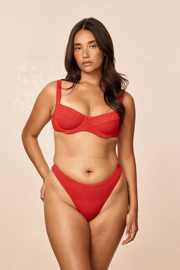 Front view of Seychelles Bottom in Chili Pepper Crinkle showcasing textured fabric and modest coverage against a beige background